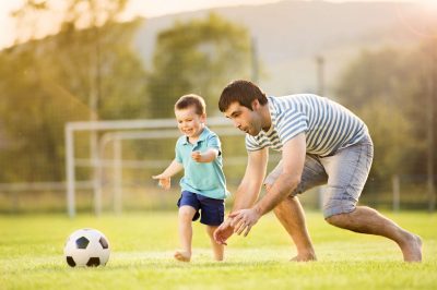 father and son play soccer