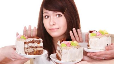 Girl refuse to eat pie. Isolated.